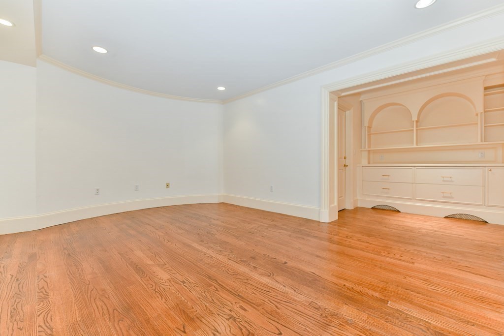 17 Willow Street, Unit 1 Boston, MA 02108 - Photo 25 of 35 a view of empty room with wooden floor and fan