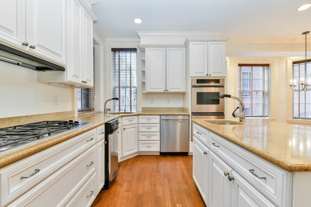 17 Willow Street, Unit 1 Boston, MA 02108 - Photo 9 of 35 a kitchen with stainless steel appliances granite countertop a stove and a sink
