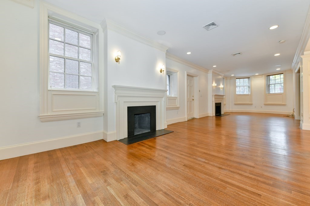 17 Willow Street, Unit 1 Boston, MA 02108 - Photo 10 of 35 a view of empty room with wooden floor and fireplace