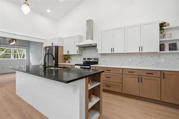 a bathroom with a tub sink and mirror