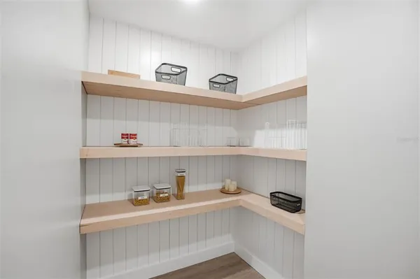 a bathroom with a white wall and a shower curtain