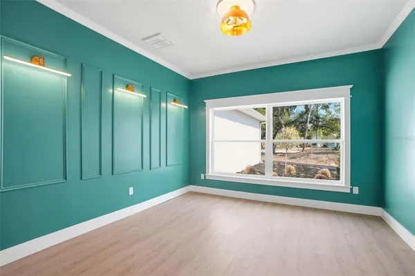 an aerial view of residential houses with outdoor space and trees