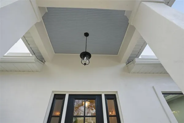 a view of empty room with wooden floor and window