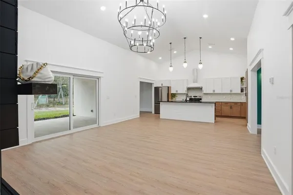 a kitchen with white cabinets a sink and wooden floor