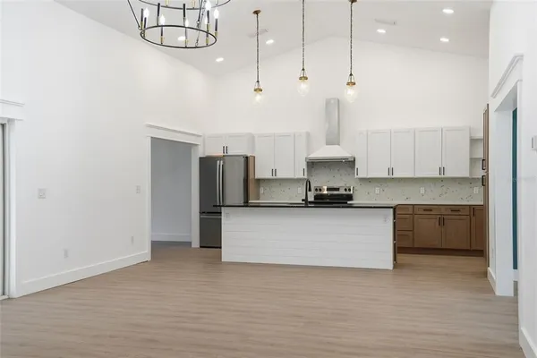 a view of an empty room with a fan and a window