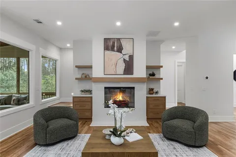 a kitchen with a sink a stove a dining table and chairs
