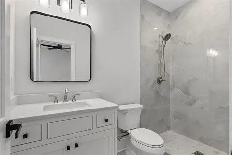 a view of a big room with wooden floor and windows