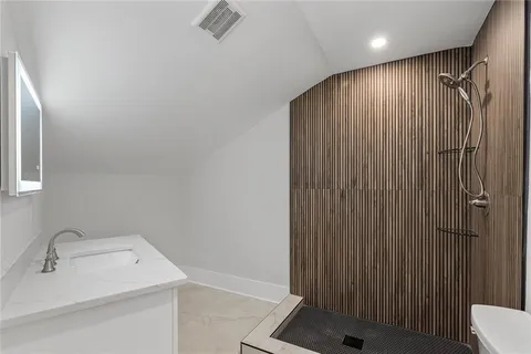 a view of a house with a yard and a large tree