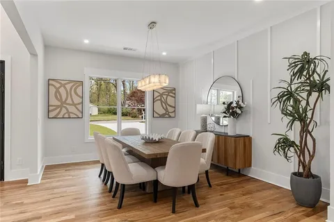 a living room with furniture kitchen view and a large window