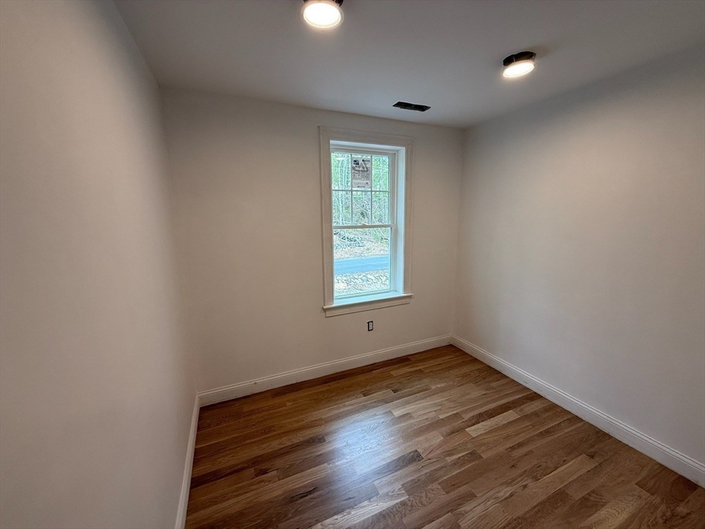 120 Maple Street Stow, MA 01775 - Photo 22 of 36 wooden floor in an empty room with a window