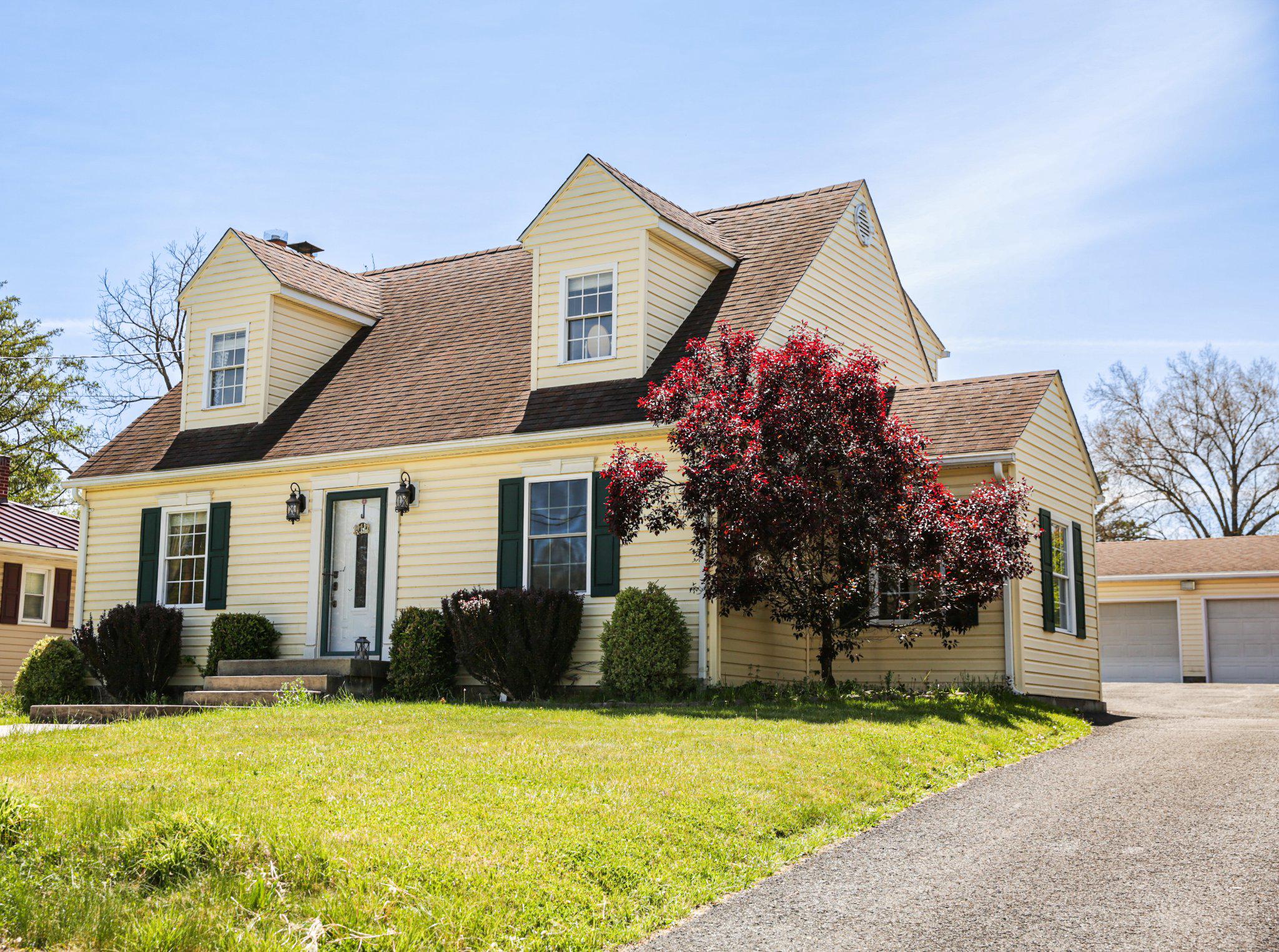 174 Armstrong Street Romney, WV 26757 - Photo 1 of 28 Charming yellow Cape Cod home with vibrant blooms.