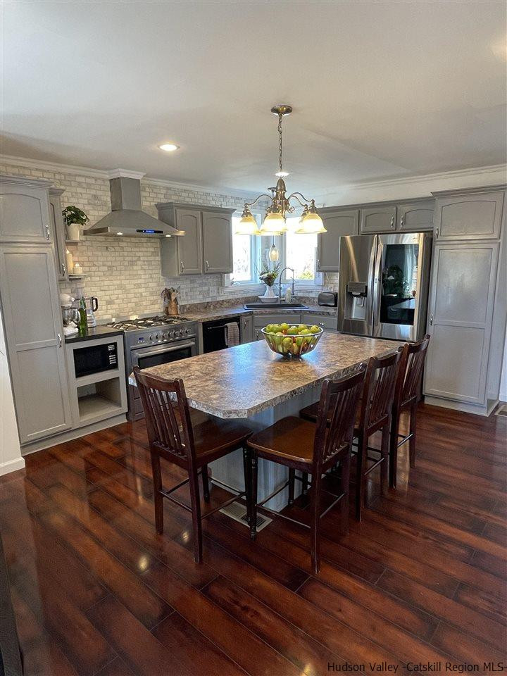 434 Cottekill Road Kingston, NY 12401 - Photo 17 of 35 a view of a dining room with furniture wooden floor and chandelier