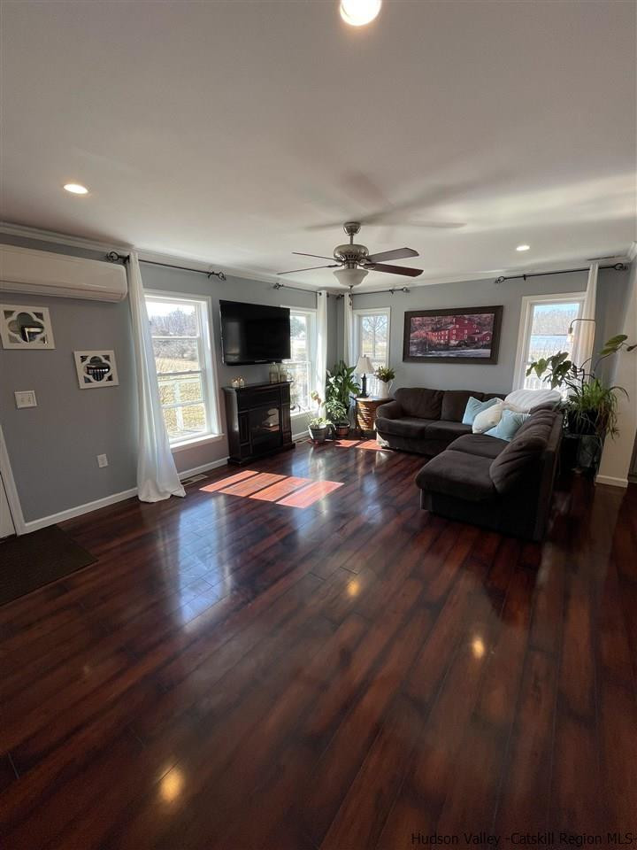 434 Cottekill Road Kingston, NY 12401 - Photo 20 of 35 a living room with furniture a fireplace and a flat screen tv