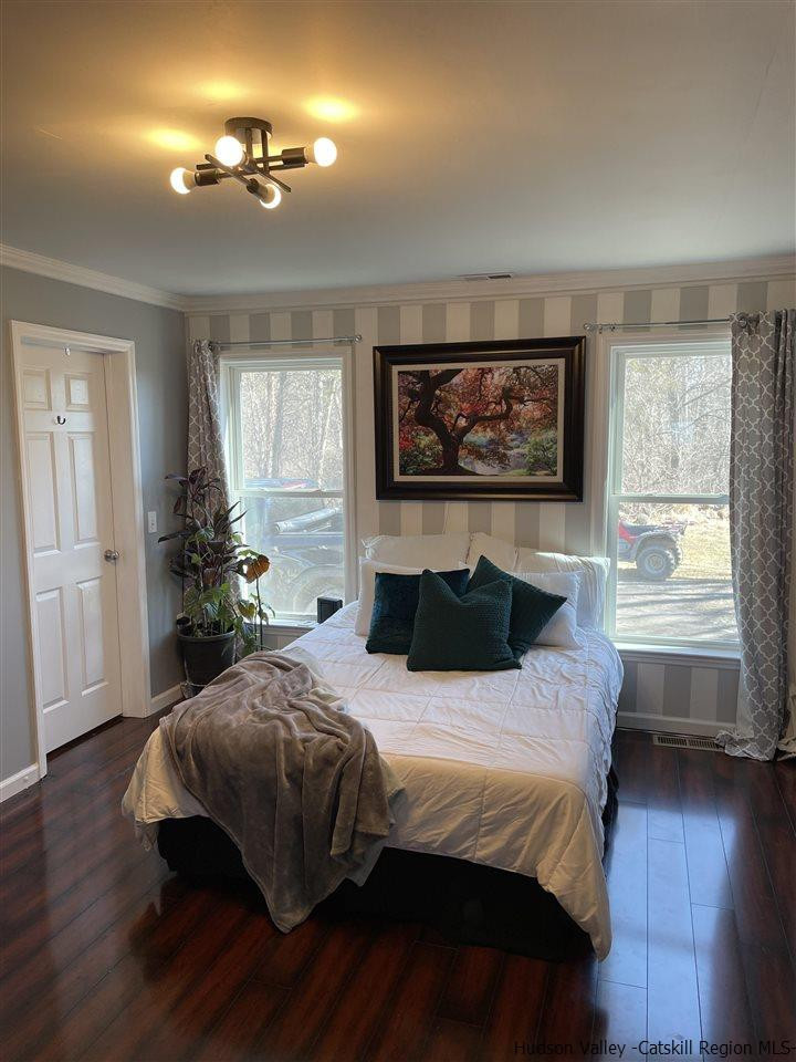 434 Cottekill Road Kingston, NY 12401 - Photo 22 of 35 a bedroom with a bed and wooden floor