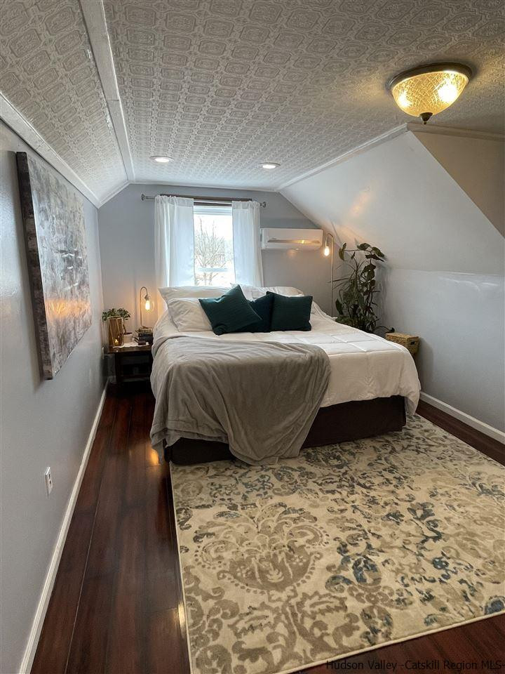 434 Cottekill Road Kingston, NY 12401 - Photo 4 of 35 a bedroom with a bed and wooden floor