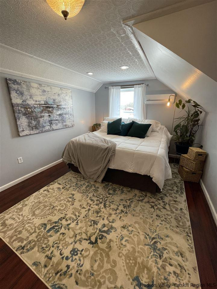 434 Cottekill Road Kingston, NY 12401 - Photo 5 of 35 a bedroom with a bed and wooden floor