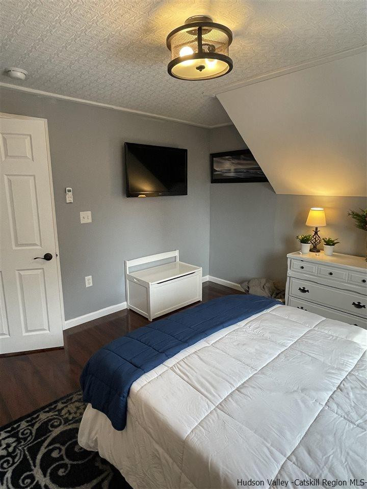 434 Cottekill Road Kingston, NY 12401 - Photo 10 of 35 a bedroom with a bed and a chandelier