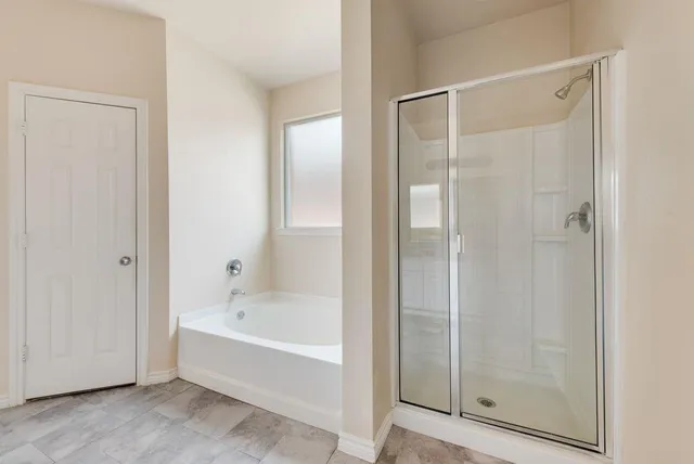 a white bath tub sitting next to a shower