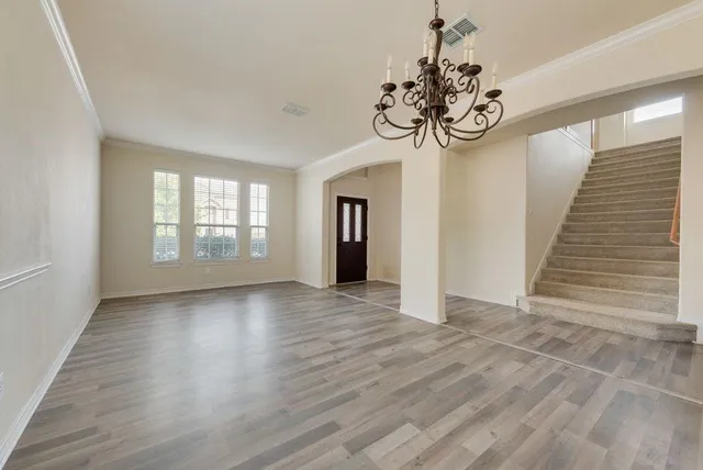 a view of an room with wooden floor and windows