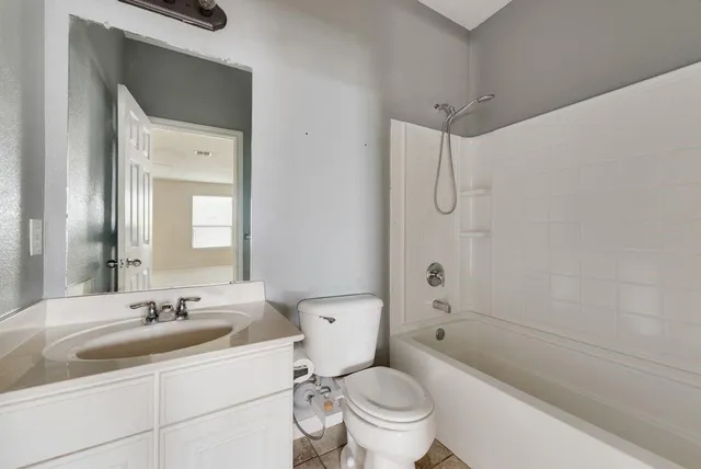 a bathroom with a sink toilet vanity and shower