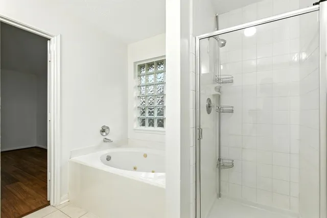 a bathroom with a bathtub and a shower