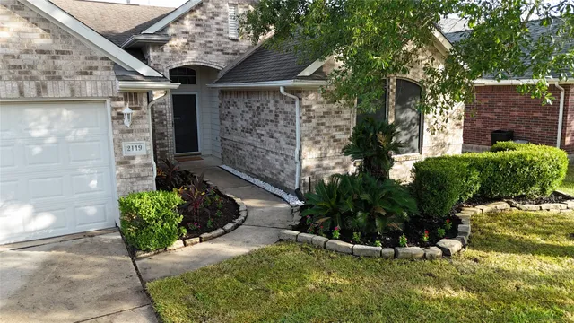 a view of a pathway of house with yard