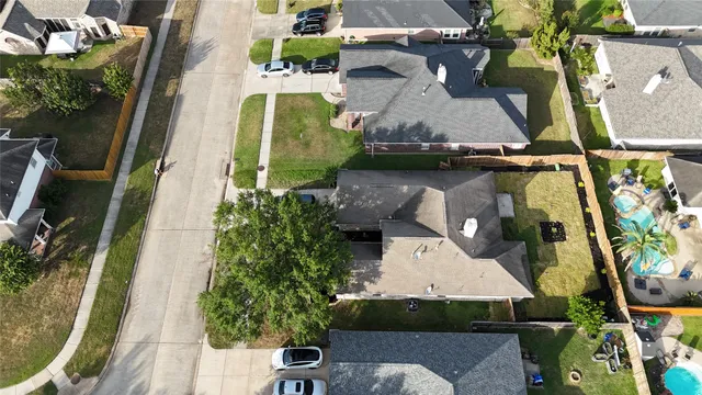 an aerial view of a house with a yard