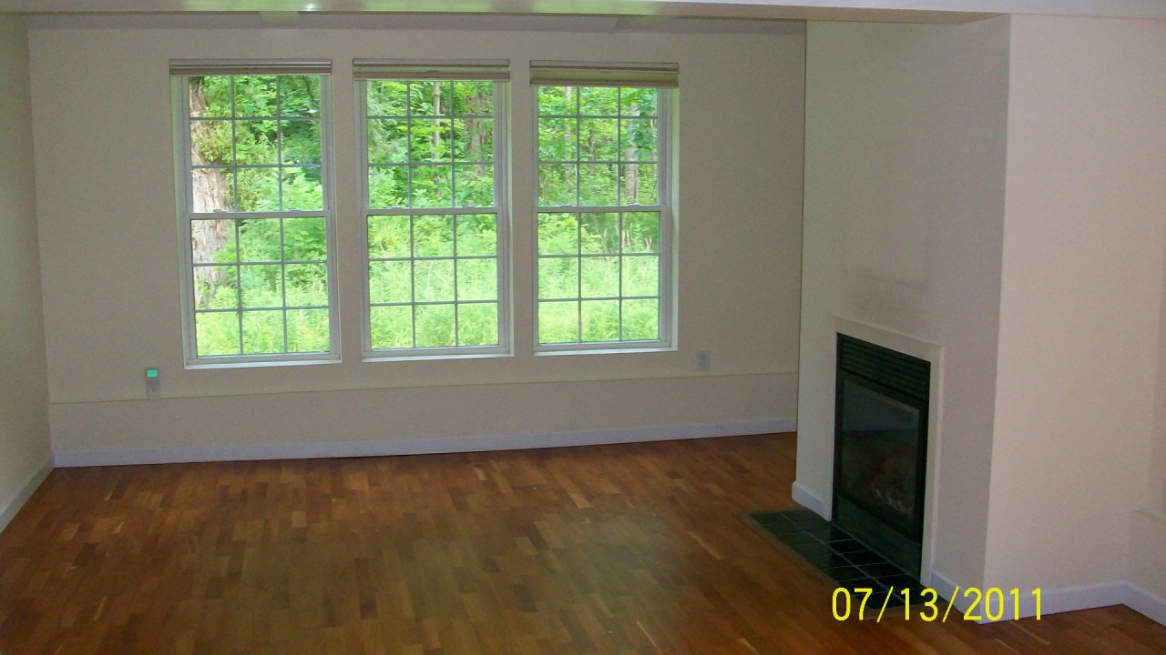 72 Interlaken Road, Unit 3 West Stockbridge, MA 01266 - Photo 5 of 10 a view of an empty room with wooden floor and a window