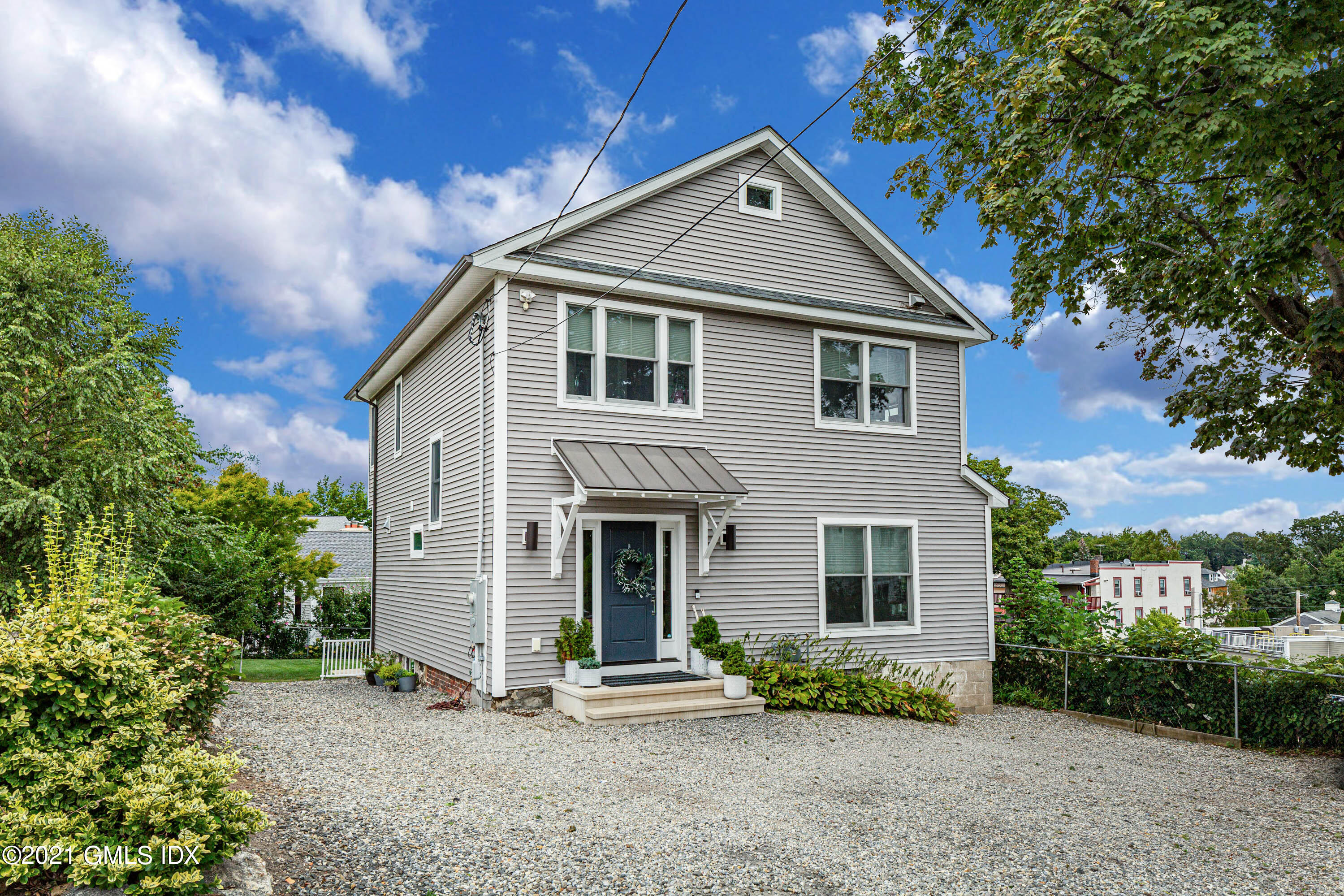 19 Ritch Avenue Greenwich, CT 06830 - Photo 2 of 29 a front view of a house with a yard