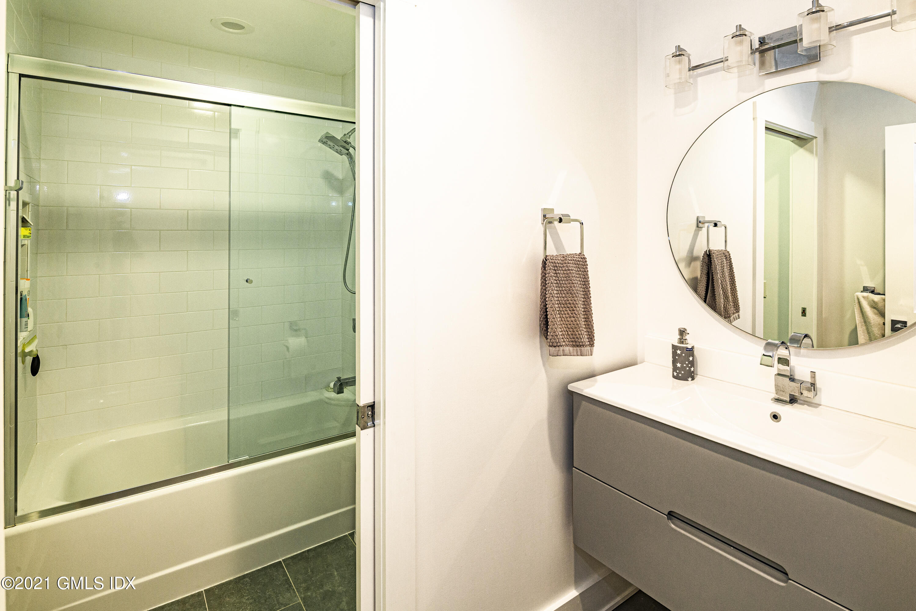 19 Ritch Avenue Greenwich, CT 06830 - Photo 22 of 29 a bathroom with a mirror sink and vanity