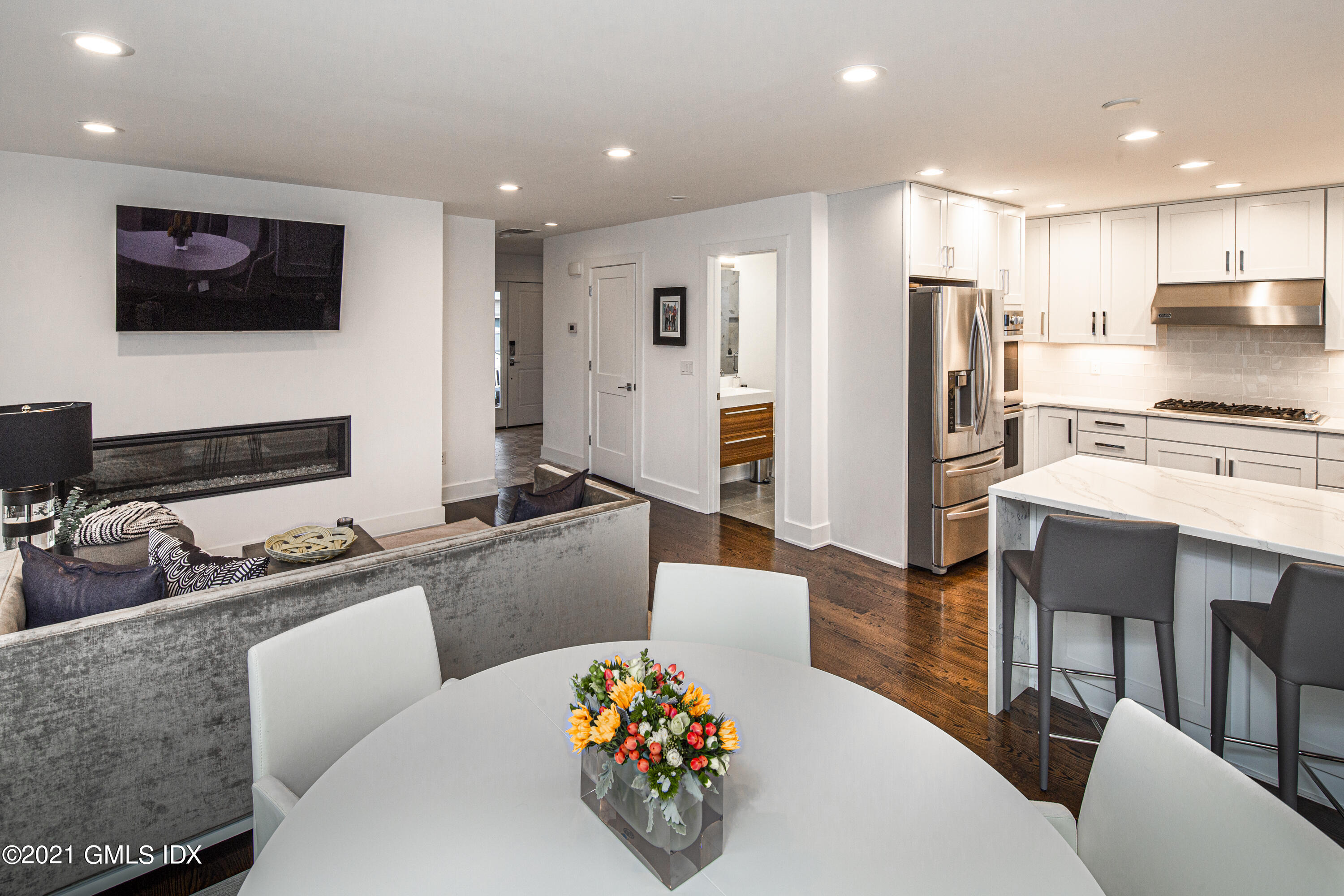 19 Ritch Avenue Greenwich, CT 06830 - Photo 7 of 29 a large kitchen with stainless steel appliances kitchen island granite countertop a dining table chairs microwave and sink