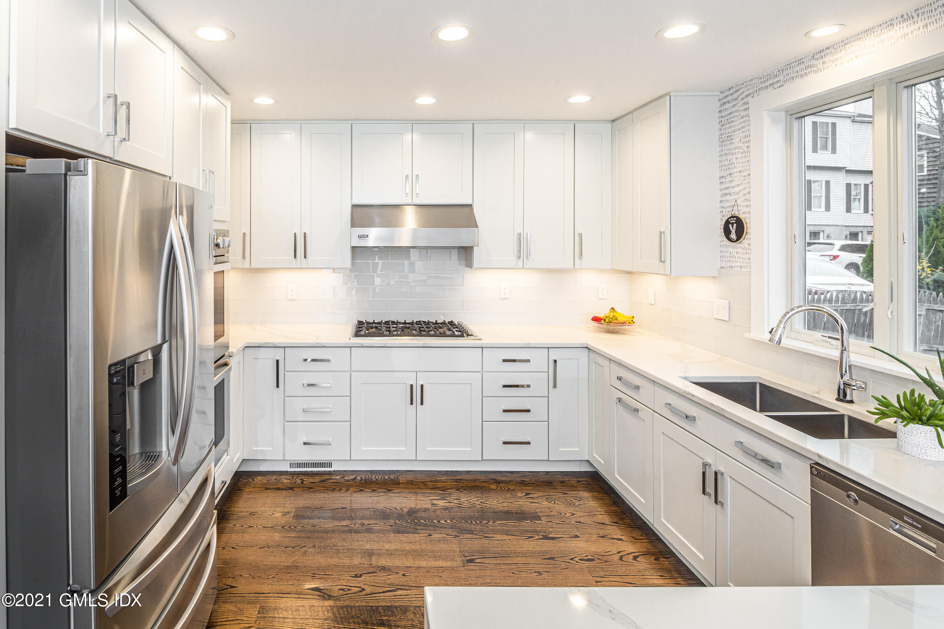 19 Ritch Avenue Greenwich, CT 06830 - Photo 9 of 29 a kitchen with white cabinets and stainless steel appliances