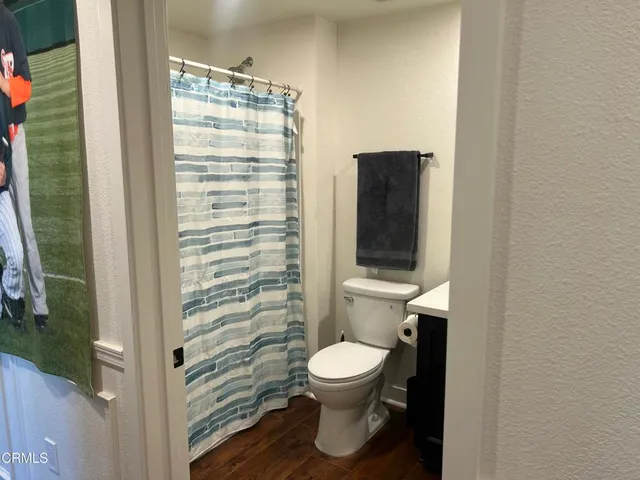 a bathroom with a toilet and a shower