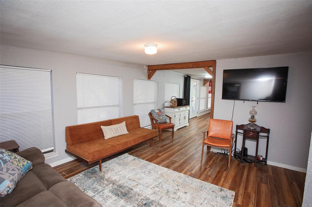 9051 Lacy Road Graford, TX 76449 - Photo 17 of 23 a living room with furniture and a flat screen tv