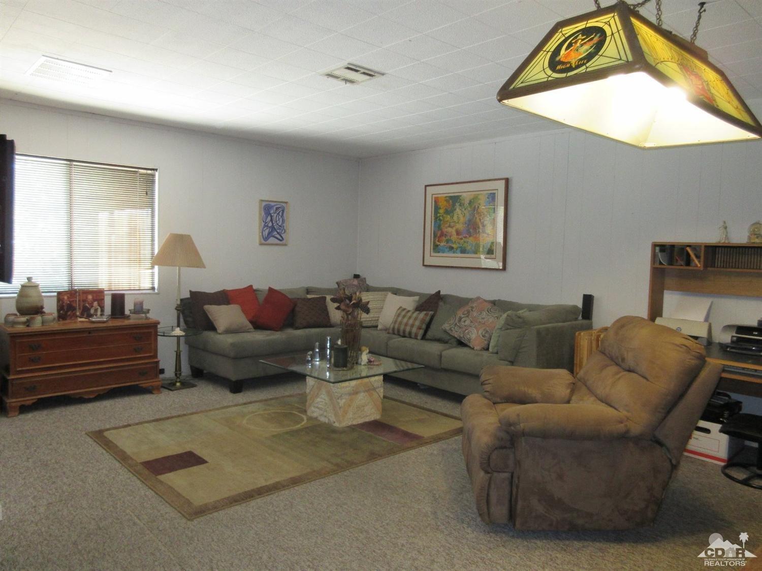36915 Palmdale Road Rancho Mirage, CA 92270 - Photo 12 of 23 a living room with furniture a rug and a window
