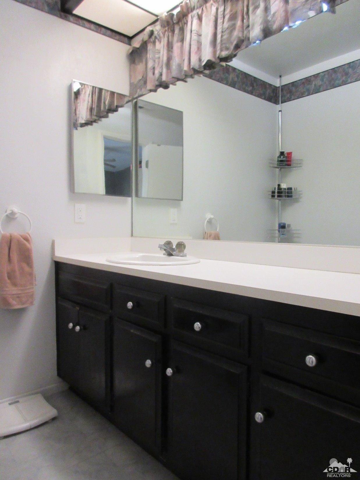 36915 Palmdale Road Rancho Mirage, CA 92270 - Photo 15 of 23 a bathroom with a sink double vanity and a mirror
