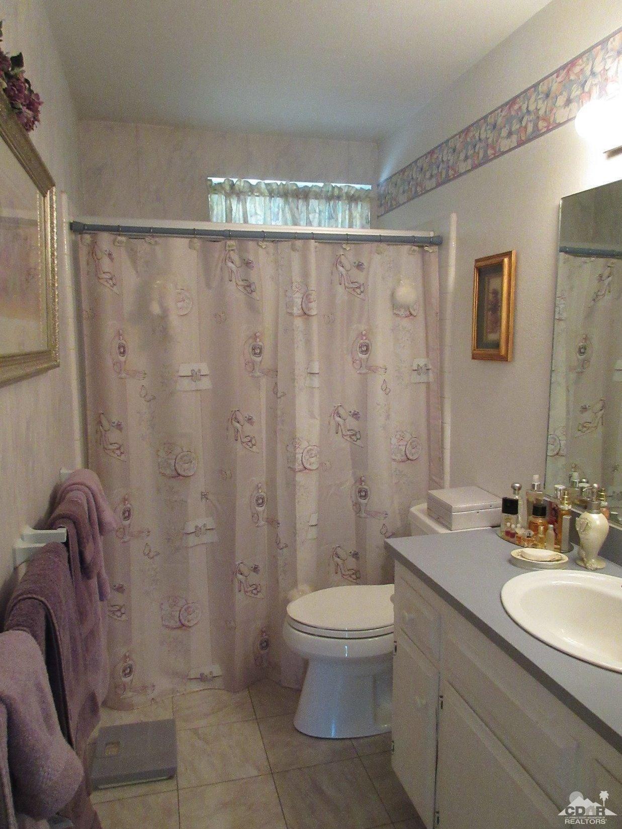 36915 Palmdale Road Rancho Mirage, CA 92270 - Photo 17 of 23 a bathroom with a sink a toilet and shower