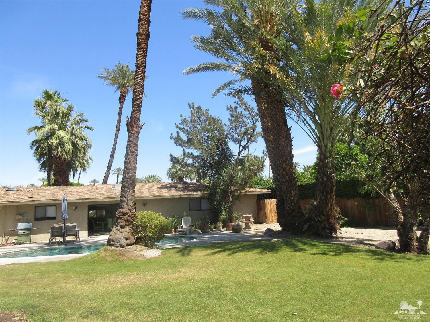 36915 Palmdale Road Rancho Mirage, CA 92270 - Photo 19 of 23 a front view of a house with a garden and trees
