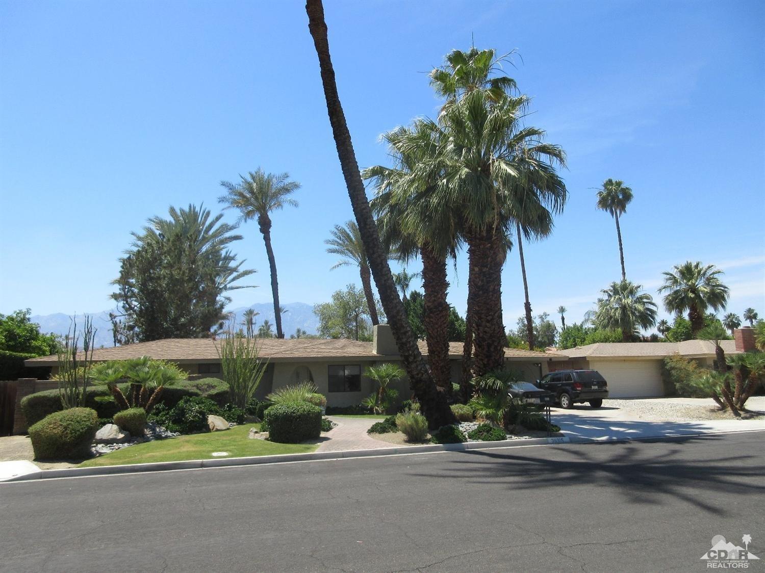 36915 Palmdale Road Rancho Mirage, CA 92270 - Photo 23 of 23 a palm tree sitting in front of a house with potted plants