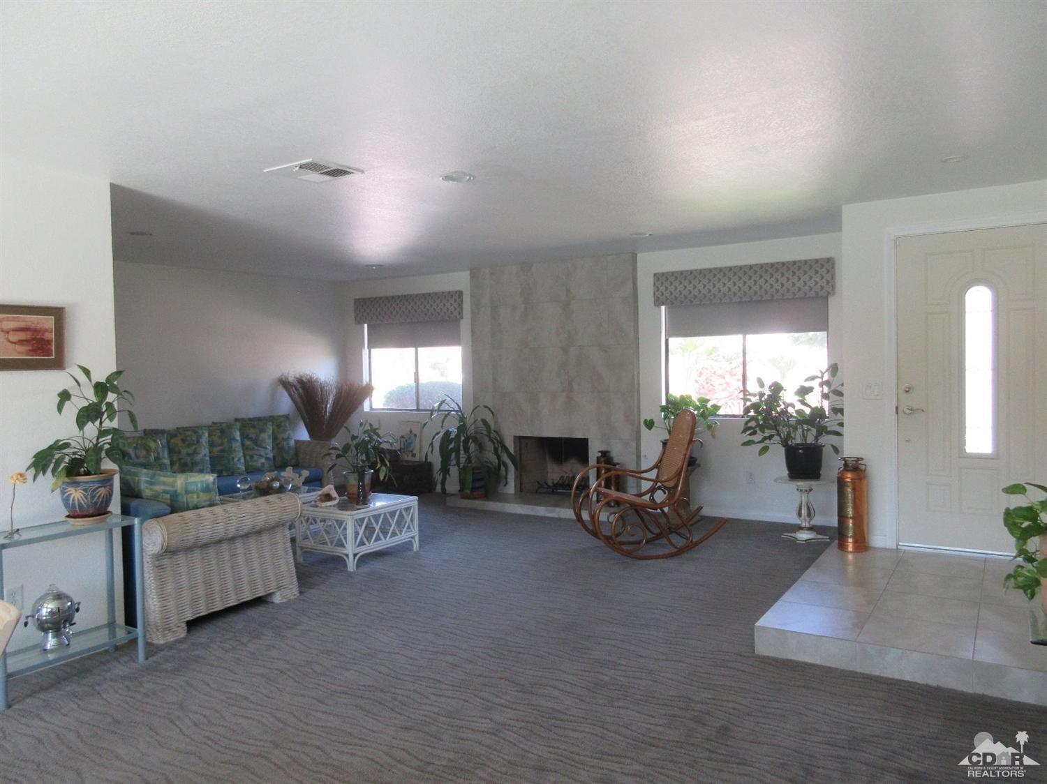 36915 Palmdale Road Rancho Mirage, CA 92270 - Photo 4 of 23 a living room with furniture and a potted plant