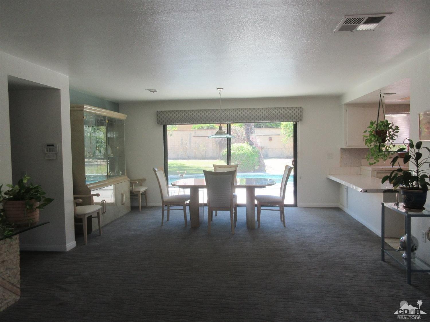 36915 Palmdale Road Rancho Mirage, CA 92270 - Photo 7 of 23 a dining room with furniture and a large window