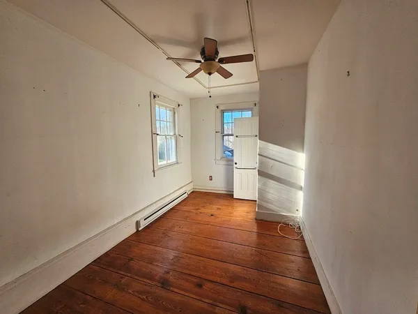 a view of gallery with wooden floor