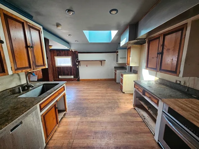 a kitchen with a stove sink and a refrigerator