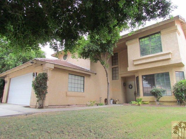45880 Sutter Creek Road Indio, CA 92201 - Photo 1 of 42 a front view of a house with a yard and garage