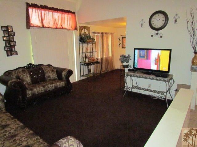 45880 Sutter Creek Road Indio, CA 92201 - Photo 8 of 42 a living room with furniture and a flat screen tv