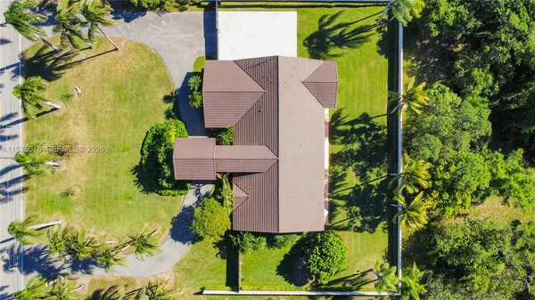 an aerial view of a house with a yard