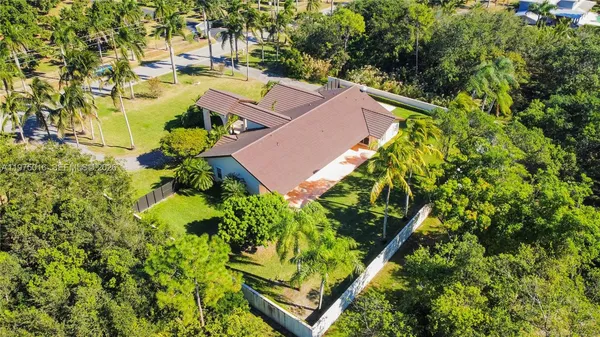 an aerial view of a house with a yard and lake view