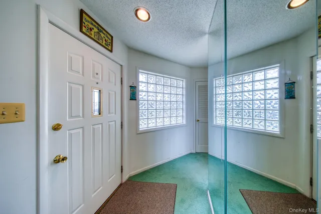 a view of an entryway with wooden floor