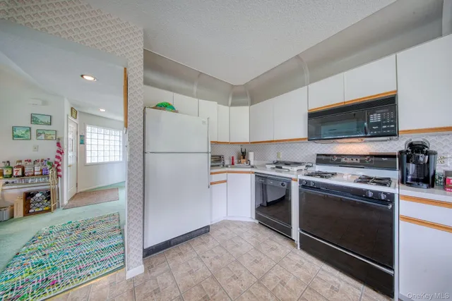a kitchen with stainless steel appliances granite countertop a refrigerator sink and stove