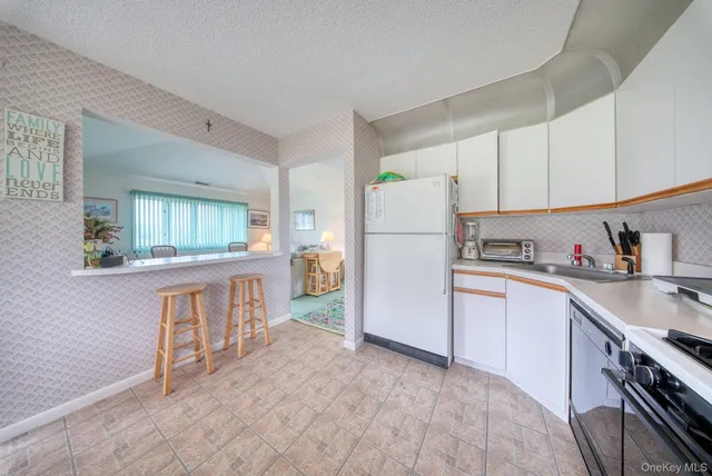 a kitchen with stainless steel appliances a refrigerator sink and cabinets